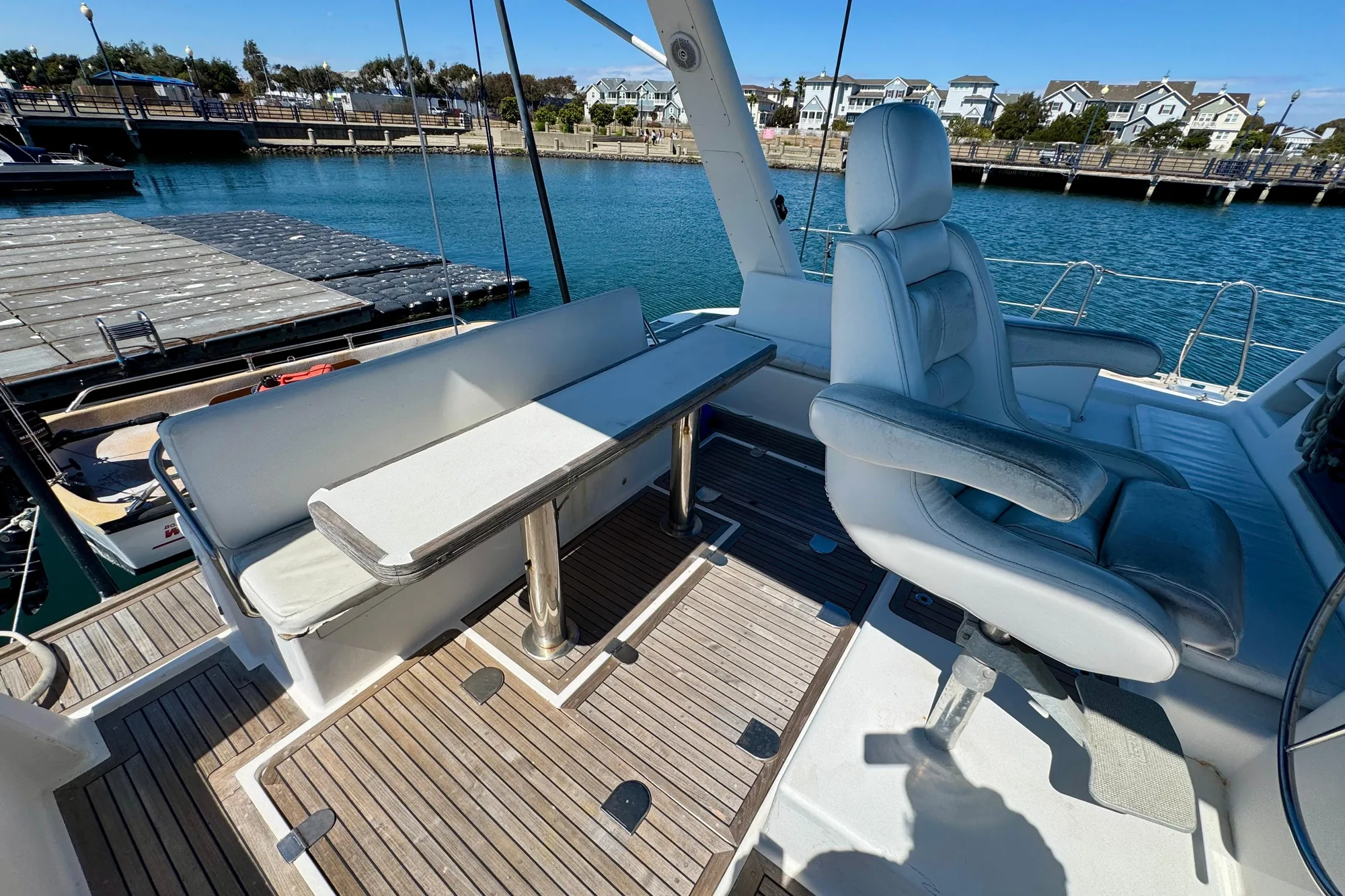Luxury seating area on a 1992 Wauquiez Kronos yacht, docked at a marina.