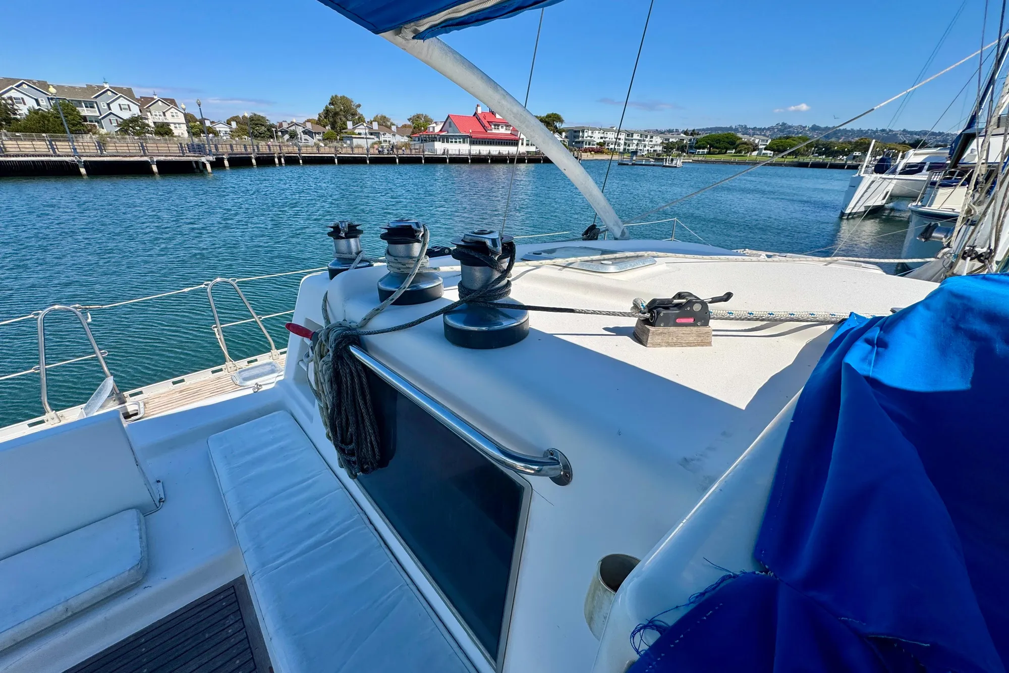 Sailboat deck view of 1992 Wauquiez Kronos, docked in a scenic marina.