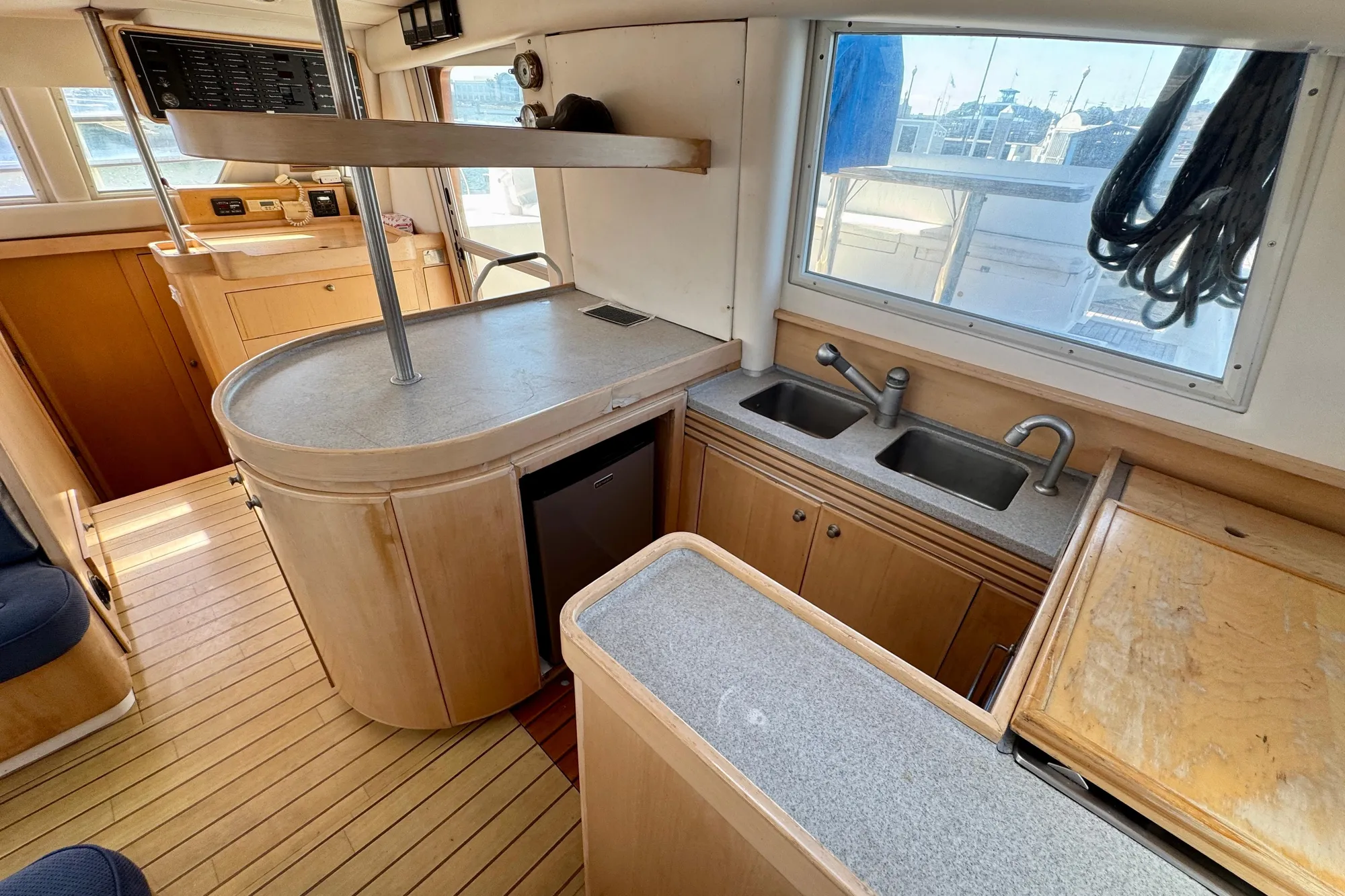 Interior of 1992 Wauquiez Kronos yacht with modern kitchen and wooden cabinetry.