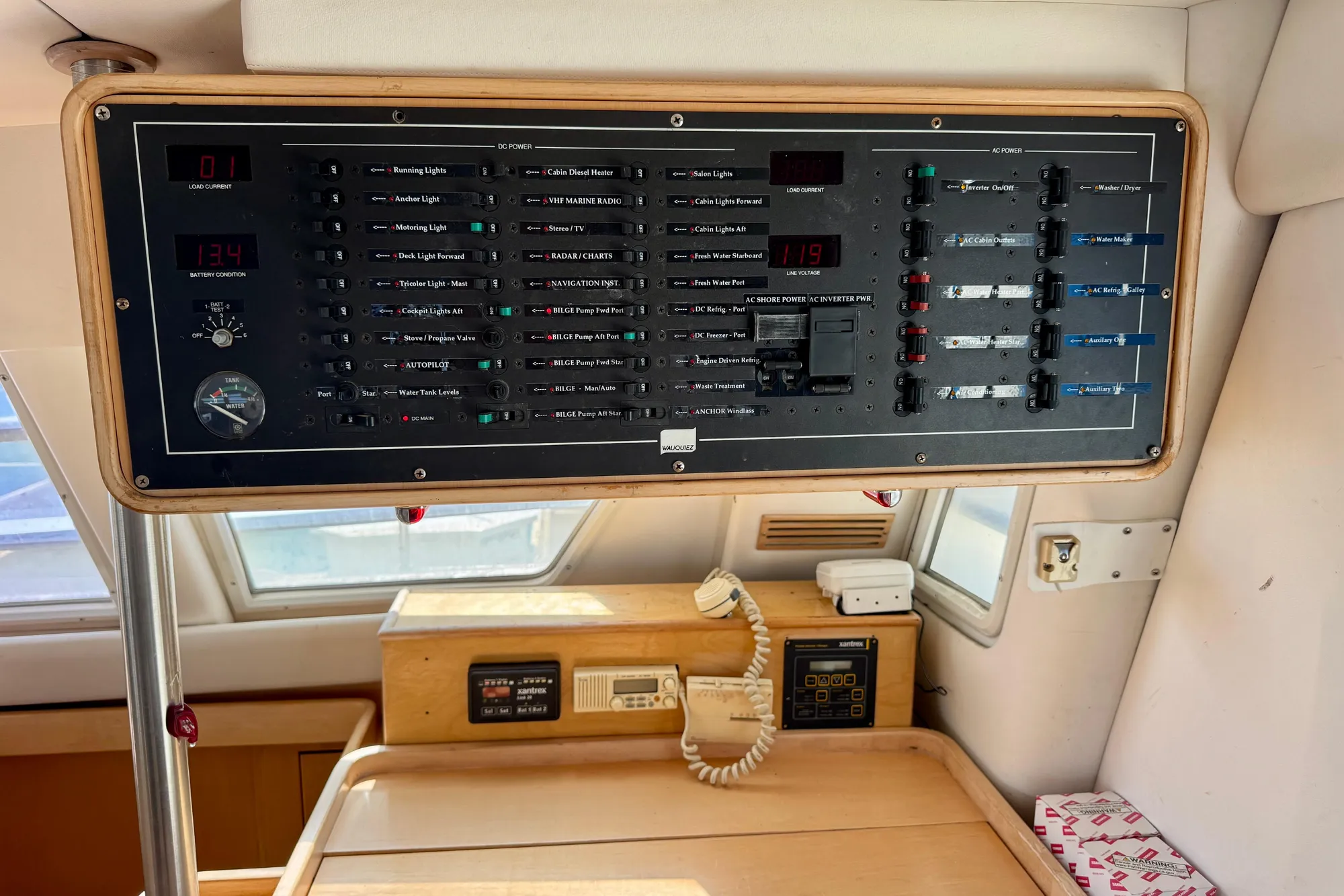 Control panel inside 1992 Wauquiez Kronos yacht, featuring various switches and gauges.