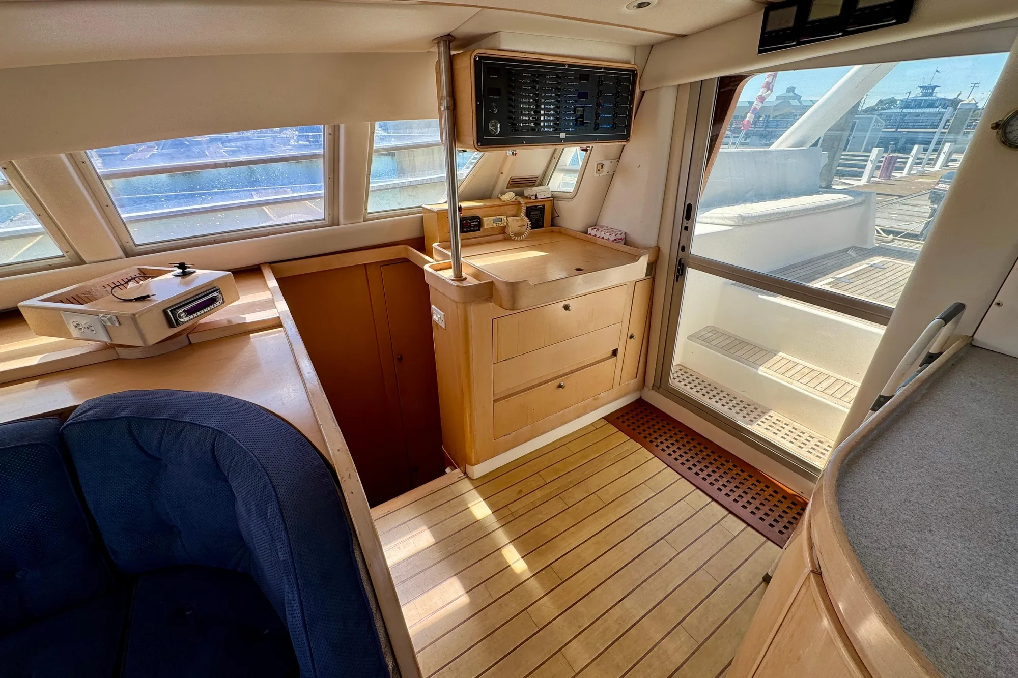 Interior of 1992 Wauquiez Kronos yacht with wooden flooring and navigation equipment.