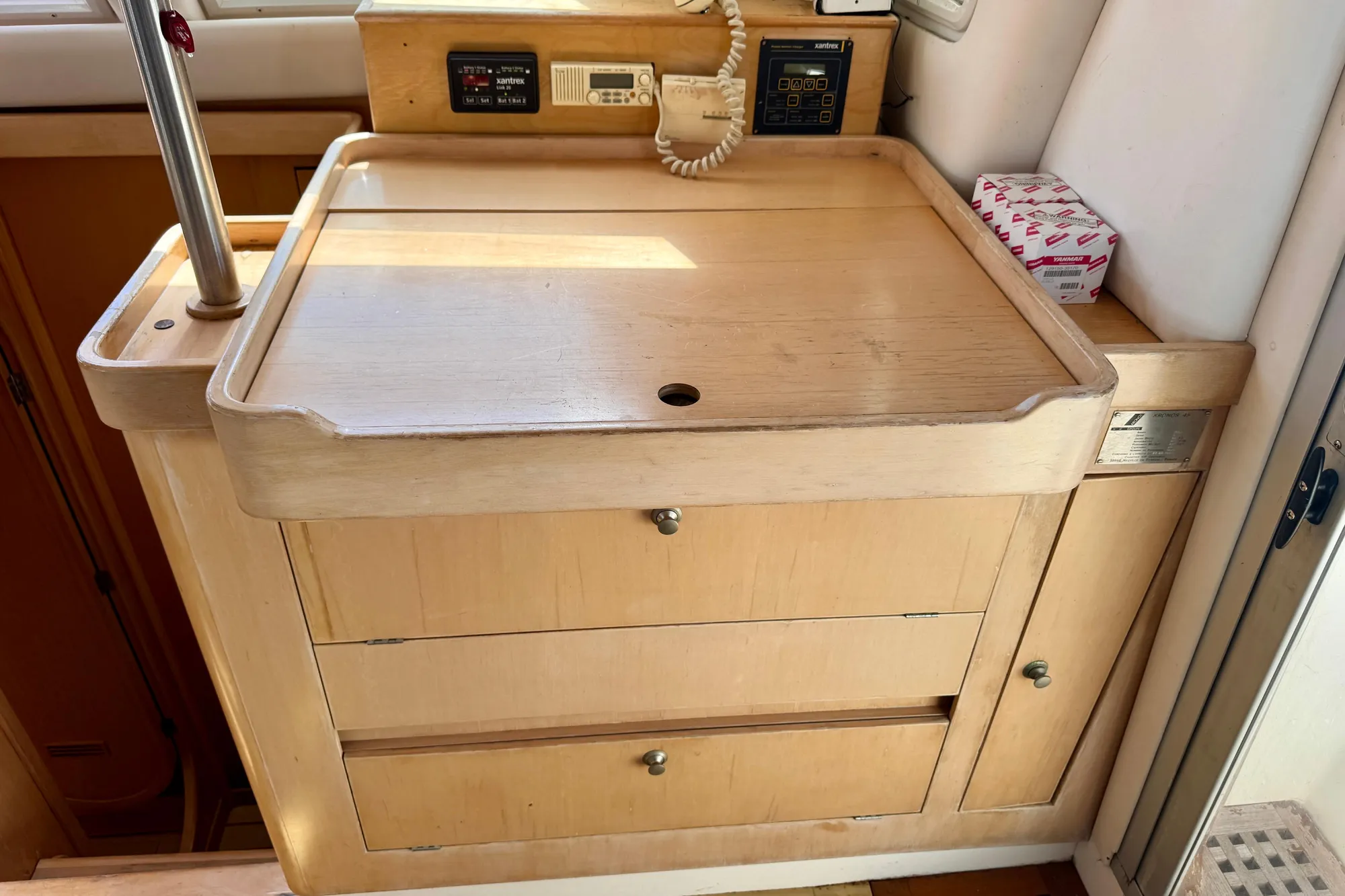 Interior of 1992 Wauquiez Kronos yacht with wooden cabinetry and control panels.