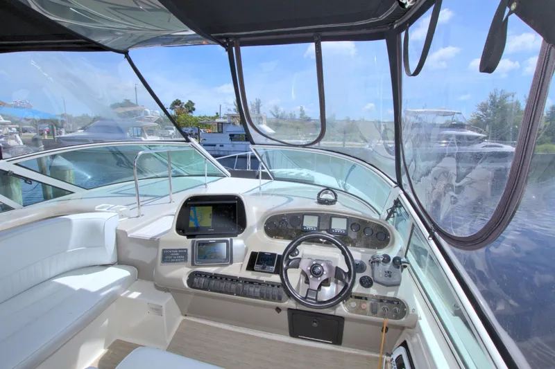 High Hopes Yacht Photos Pics Interior view of 2004 Cruisers Yachts 370 Express helm with navigation equipment and steering wheel.