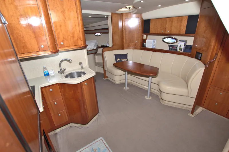 High Hopes Yacht Photos Pics 2004 Cruisers Yachts 370 Express interior with kitchenette and seating area.