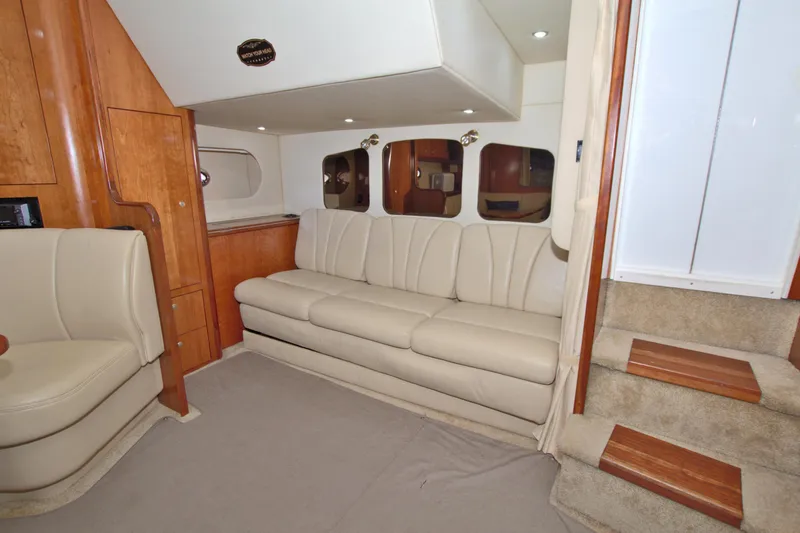 High Hopes Yacht Photos Pics Interior of 2004 Cruisers Yachts 370 Express with beige seating and wooden accents.