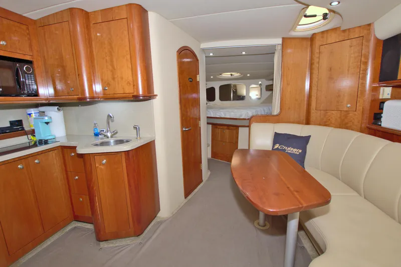 High Hopes Yacht Photos Pics 2004 Cruisers Yachts 370 Express interior with kitchenette, seating, and sleeping area.