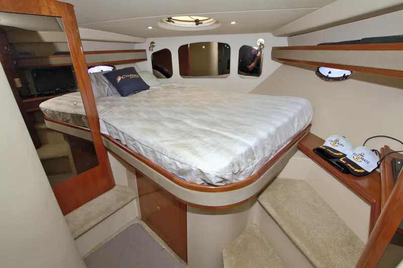 High Hopes Yacht Photos Pics 2004 Cruisers Yachts 370 Express cabin interior with bed and storage shelves.