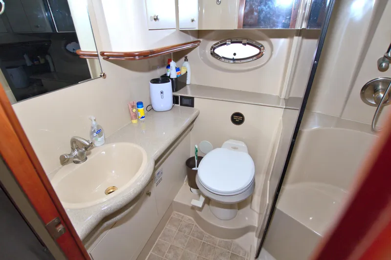 High Hopes Yacht Photos Pics Bathroom interior of 2004 Cruisers Yachts 370 Express, featuring sink, toilet, and shower.