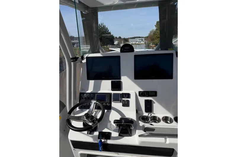  Yacht Photos Pics 2021 Cape Horn 32 XS boat dashboard with dual screens and steering wheel.