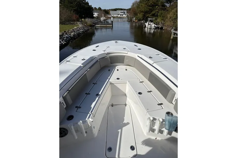  Yacht Photos Pics 2021 Cape Horn 32 XS boat interior with spacious seating and storage, docked in a serene canal.