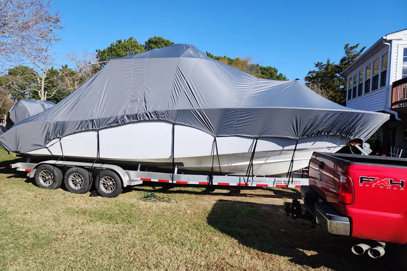  Yacht Photos Pics 2021 Cape Horn 32 XS boat covered on trailer, hitched to red truck.