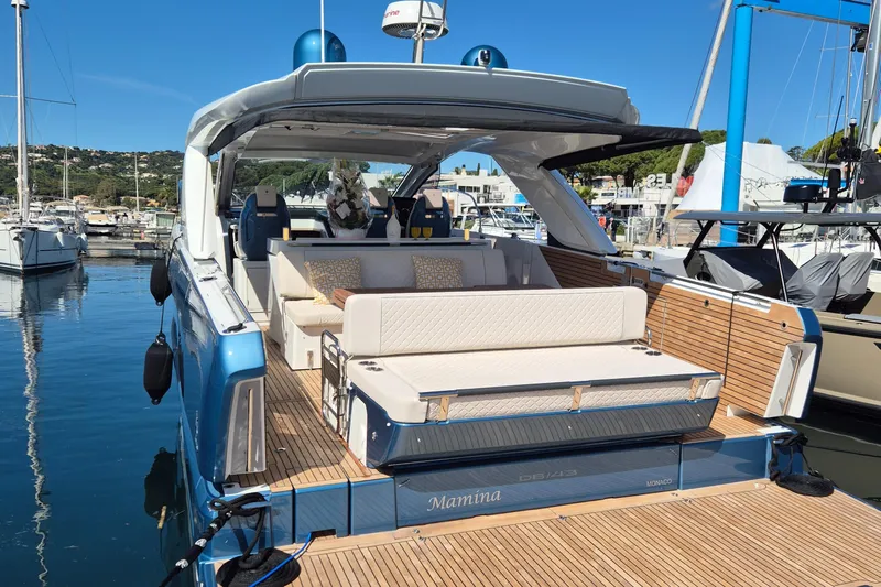 Mamina Yacht Photos Pics 2024 Jeanneau DB/43 IB luxury yacht docked, featuring elegant seating and sleek design.