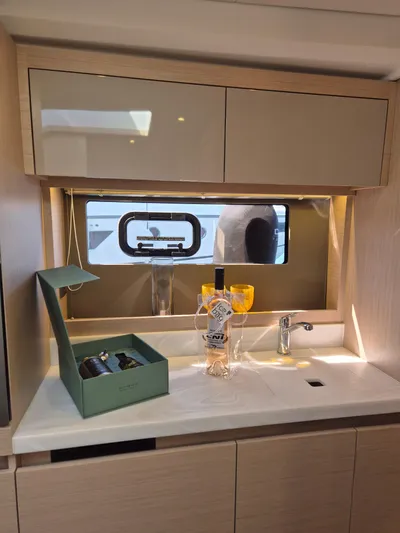 Mamina Yacht Photos Pics Luxurious interior of 2024 Jeanneau DB/43 IB yacht with elegant cabinetry and countertop.