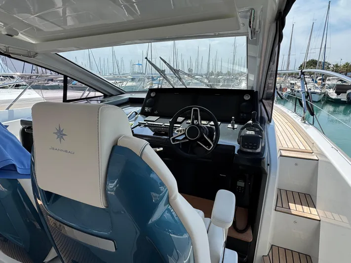 Mamina Yacht Photos Pics 2024 Jeanneau DB/43 IB yacht helm with modern controls and marina view.