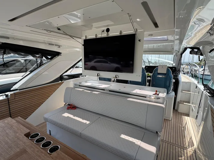 Mamina Yacht Photos Pics Luxurious interior of 2024 Jeanneau DB/43 IB yacht with seating and mounted TV.