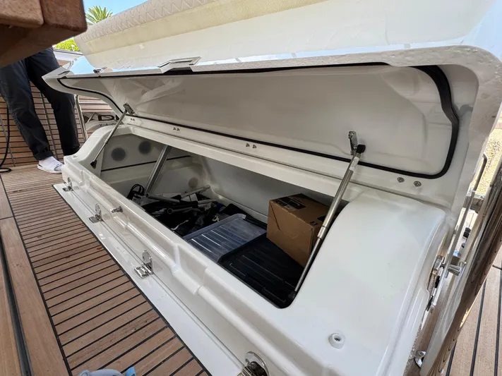 Mamina Yacht Photos Pics 2024 Jeanneau DB/43 IB boat storage compartment with open lid on teak deck.