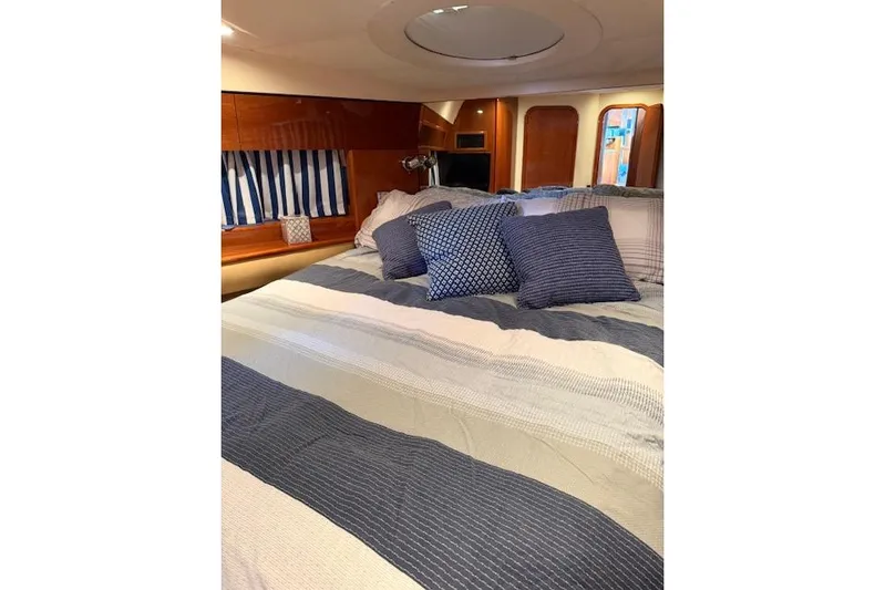  Yacht Photos Pics Luxurious cabin interior of 2003 Viking Princess 50 Sport Cruiser with striped bedding.