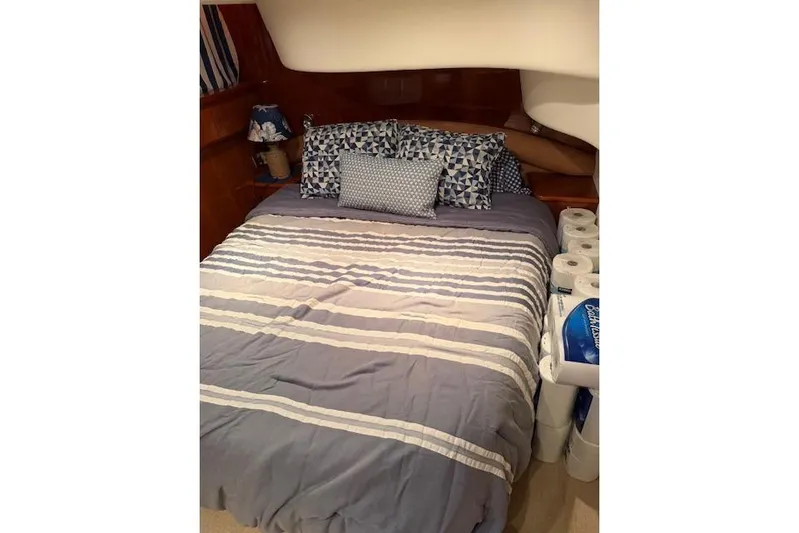  Yacht Photos Pics Cozy bedroom in 2003 Viking Princess 50 Sport Cruiser with striped bedding and decorative pillows.
