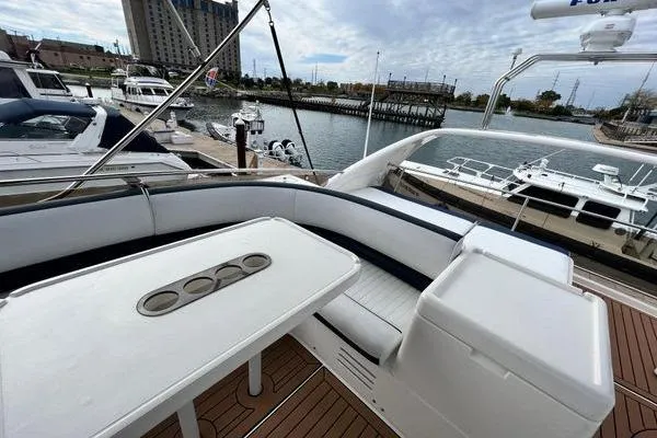  Yacht Photos Pics 2003 Viking Princess 50 Sport Cruiser yacht with spacious deck and seating area at marina.