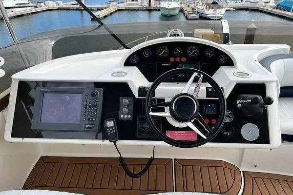  Yacht Photos Pics 2003 Viking Princess 50 Sport Cruiser helm with navigation equipment and steering wheel.