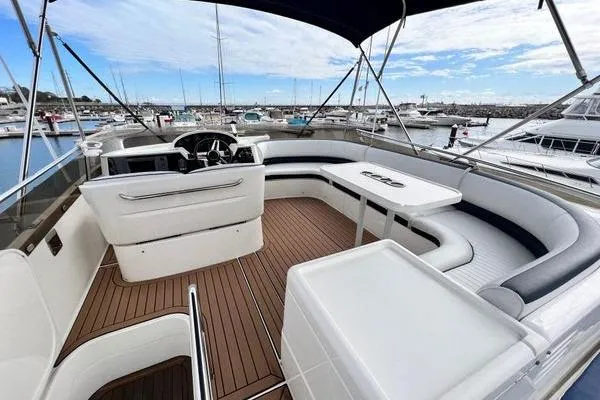  Yacht Photos Pics 2003 Viking Princess 50 Sport Cruiser with spacious deck and seating in marina setting.