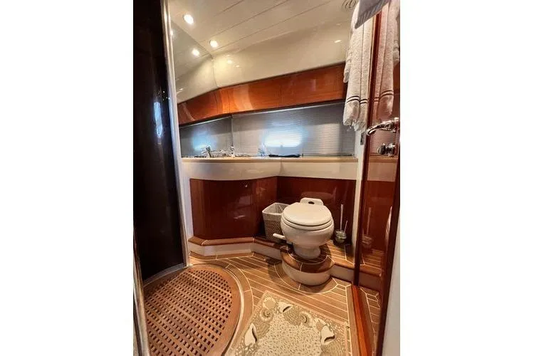  Yacht Photos Pics Luxurious bathroom in 2003 Viking Princess 50 Sport Cruiser yacht, featuring elegant wood finishes.