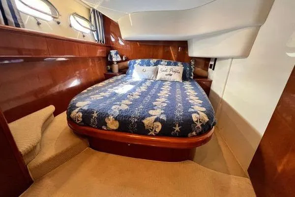  Yacht Photos Pics Luxurious cabin interior of 2003 Viking Princess 50 Sport Cruiser with nautical-themed bedding.