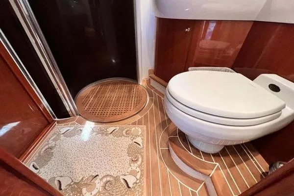  Yacht Photos Pics Luxurious bathroom in 2003 Viking Princess 50 Sport Cruiser with elegant wood accents.