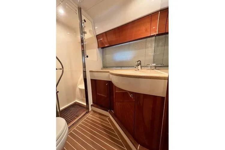  Yacht Photos Pics Luxurious bathroom in 2003 Viking Princess 50 Sport Cruiser with wood accents and modern fixtures.