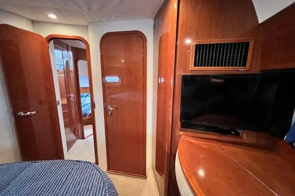  Yacht Photos Pics Interior of 2003 Viking Princess 50 Sport Cruiser with wood paneling and TV.