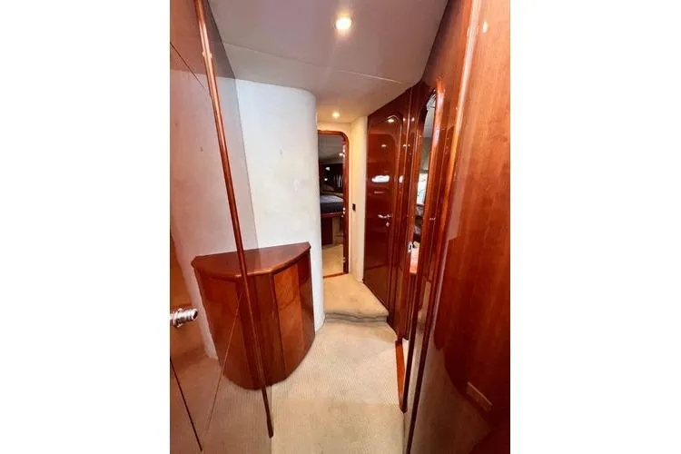  Yacht Photos Pics 2003 Viking Princess 50 Sport Cruiser interior hallway with wooden cabinetry and soft lighting.