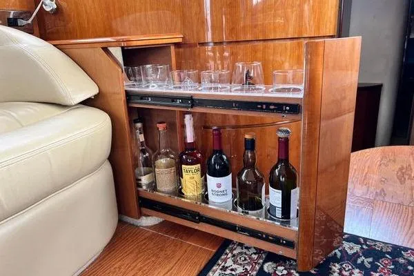  Yacht Photos Pics Bar cabinet in 2003 Viking Princess 50 Sport Cruiser with assorted bottles and glasses.