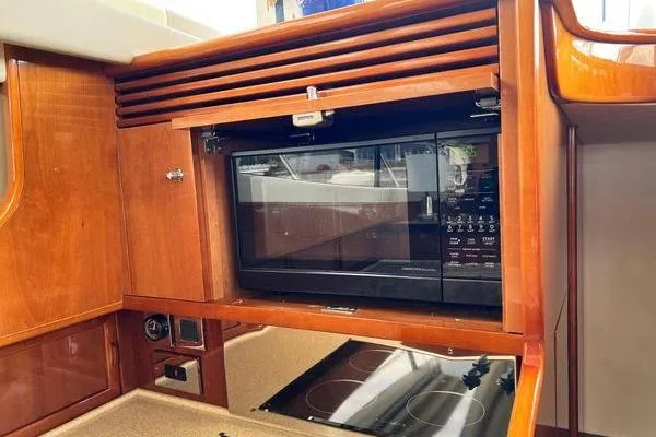  Yacht Photos Pics 2003 Viking Princess 50 Sport Cruiser kitchen with built-in microwave and stove.