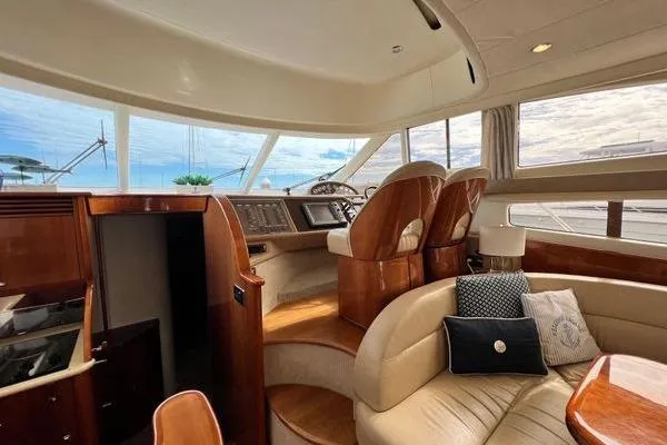  Yacht Photos Pics Luxurious interior of 2003 Viking Princess 50 Sport Cruiser yacht with plush seating and helm.