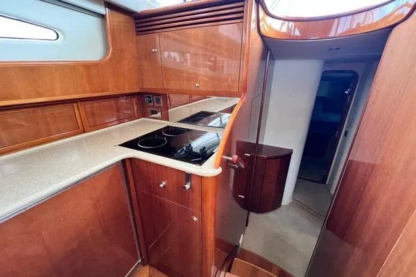  Yacht Photos Pics 2003 Viking Princess 50 Sport Cruiser kitchen with wood cabinetry and modern appliances.