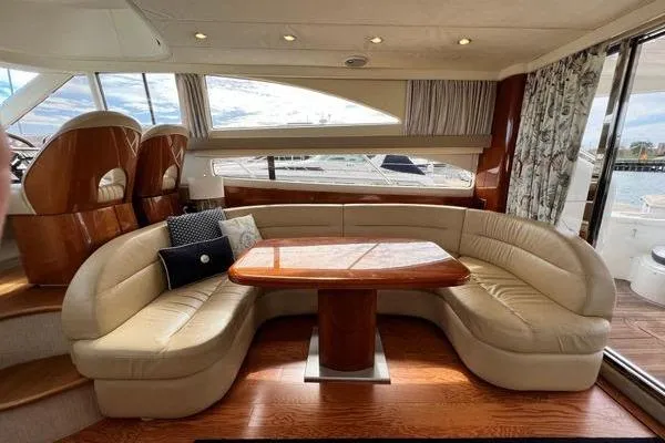  Yacht Photos Pics Luxurious interior of 2003 Viking Princess 50 Sport Cruiser with elegant seating and wooden table.