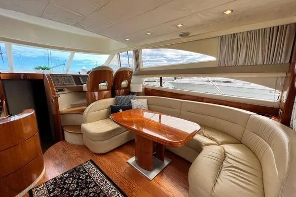  Yacht Photos Pics Luxurious interior of 2003 Viking Princess 50 Sport Cruiser with elegant seating and wooden finishes.