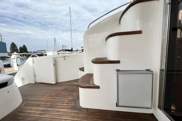  Yacht Photos Pics 2003 Viking Princess 50 Sport Cruiser with wooden deck and curved staircase.