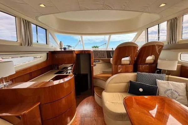  Yacht Photos Pics Luxurious interior of 2003 Viking Princess 50 Sport Cruiser with elegant wood finishes and plush seating.