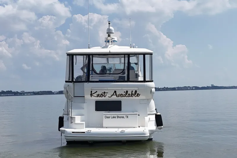 Knot Available Yacht Photos Pics 2004 Cruisers Yachts 405 Express Motoryacht on calm water, rear view, Clear Lake Shores, TX.