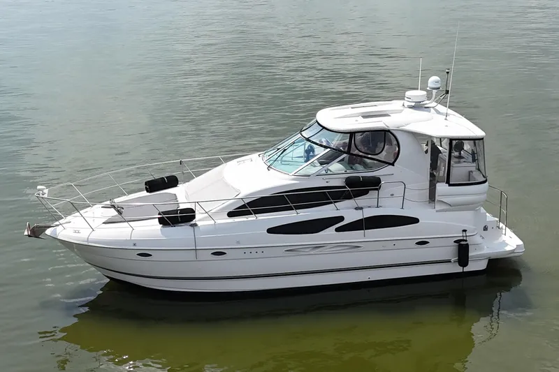 Knot Available Yacht Photos Pics 2004 Cruisers Yachts 405 Express Motoryacht on calm water, side view.