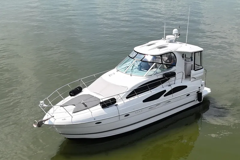 Knot Available Yacht Photos Pics 2004 Cruisers Yachts 405 Express Motoryacht on calm water, showcasing sleek design and luxury features.