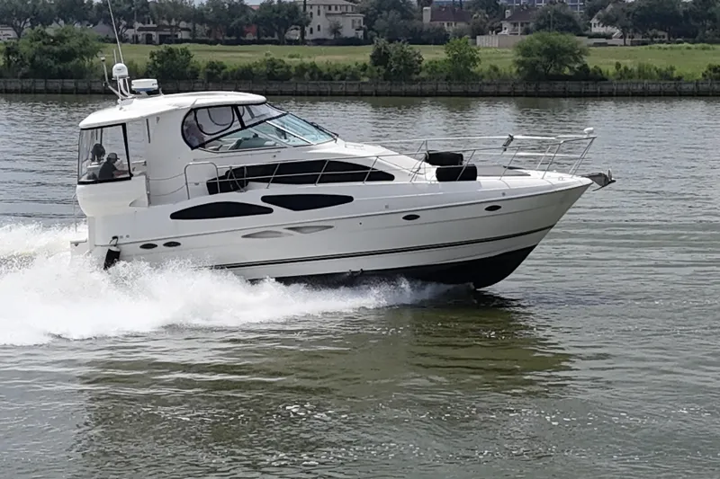 Knot Available Yacht Photos Pics 2004 Cruisers Yachts 405 Express Motoryacht cruising on a calm river.