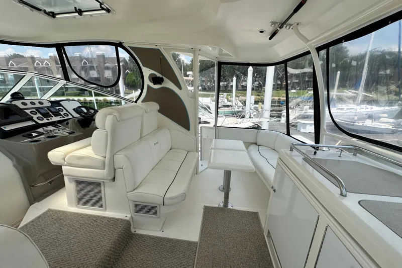 Knot Available Yacht Photos Pics Luxurious interior of 2004 Cruisers Yachts 405 Express Motoryacht with plush seating and helm.