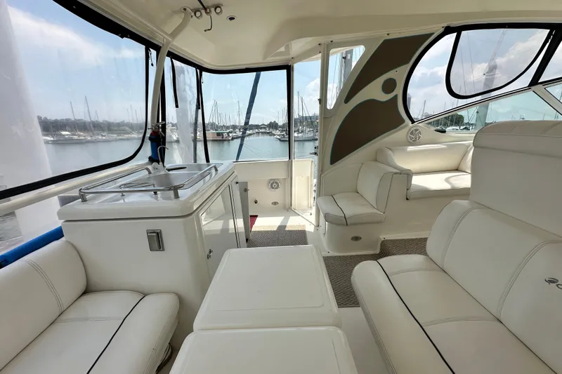Knot Available Yacht Photos Pics 2004 Cruisers Yachts 405 Express Motoryacht interior with white seating and marina view.