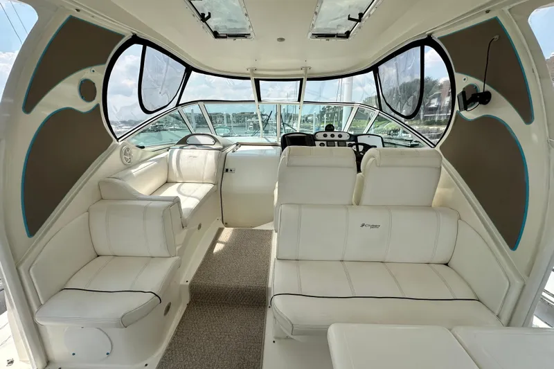 Knot Available Yacht Photos Pics 2004 Cruisers Yachts 405 Express Motoryacht interior with white seating and helm.