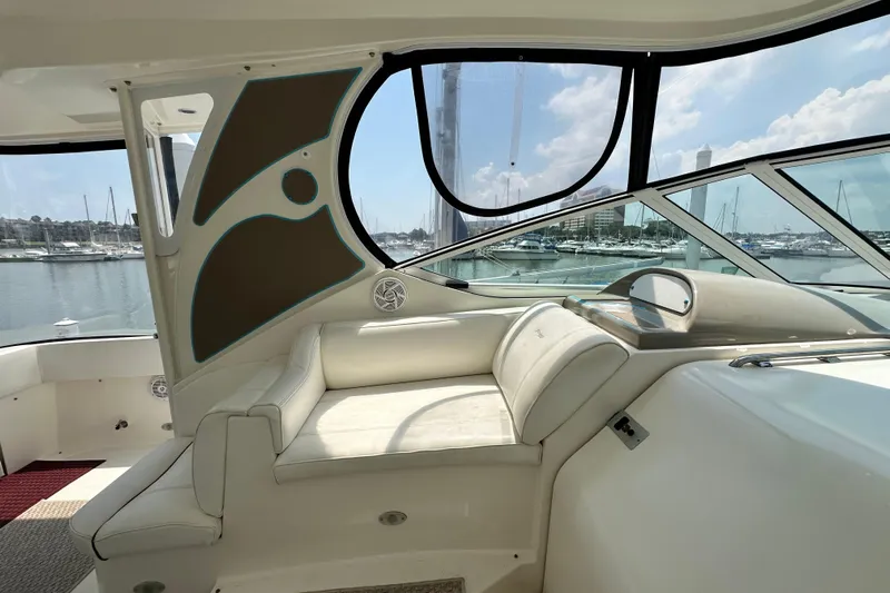 Knot Available Yacht Photos Pics 2004 Cruisers Yachts 405 Express Motoryacht interior with marina view through large windows.
