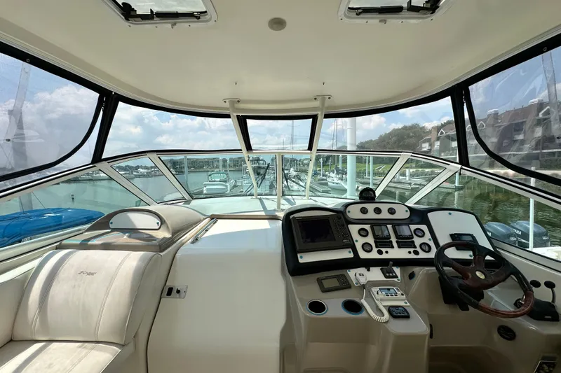 Knot Available Yacht Photos Pics 2004 Cruisers Yachts 405 Express Motoryacht helm with panoramic marina view.