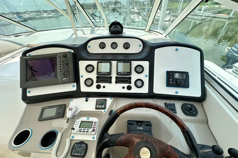 Knot Available Yacht Photos Pics 2004 Cruisers Yachts 405 Express Motoryacht helm with navigation and control instruments.