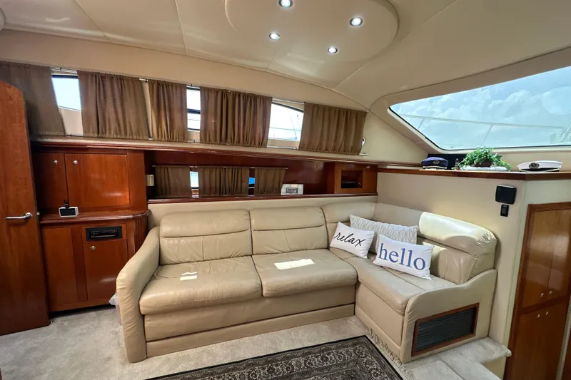 Knot Available Yacht Photos Pics Luxurious 2004 Cruisers Yachts 405 Express Motoryacht interior with beige leather seating.